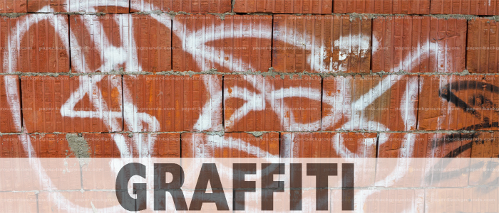 Red Brick wall with white graffiti on it